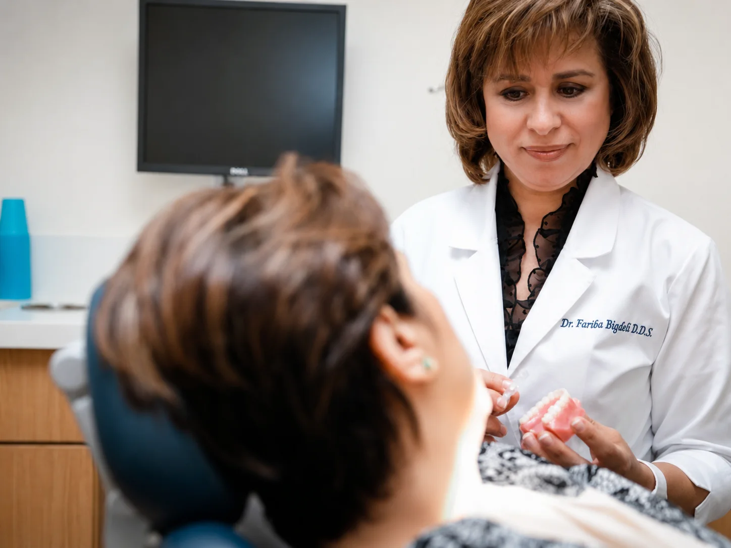 Dr. Fariba Bigdeli discussing dental care with a patient